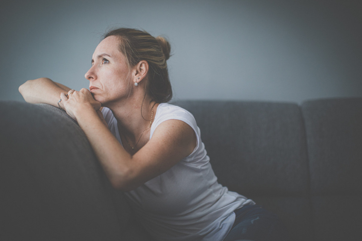 Depressed middle-aged woman at home feeling anxious