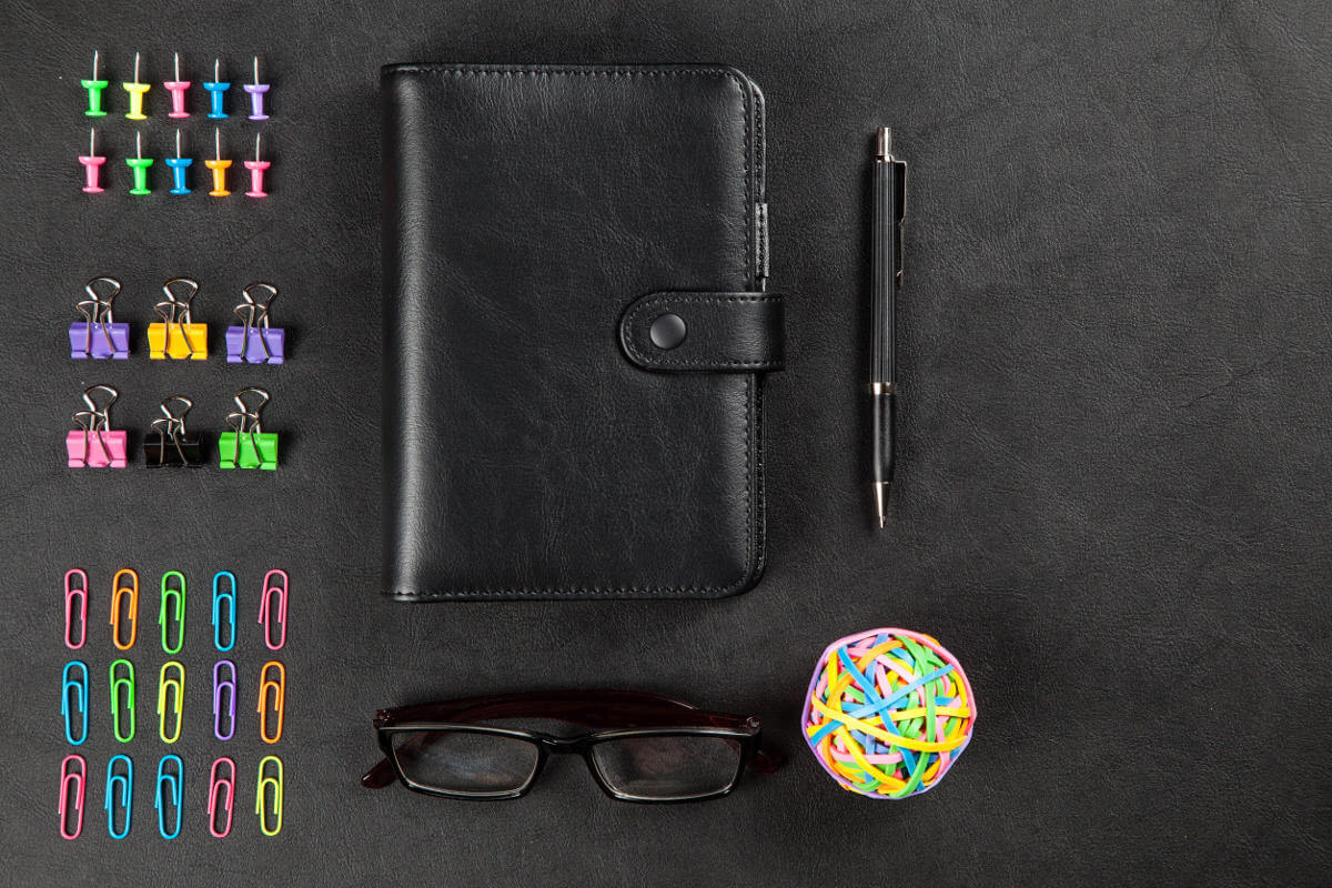 Office supplies neatly arranged on a leather surface table