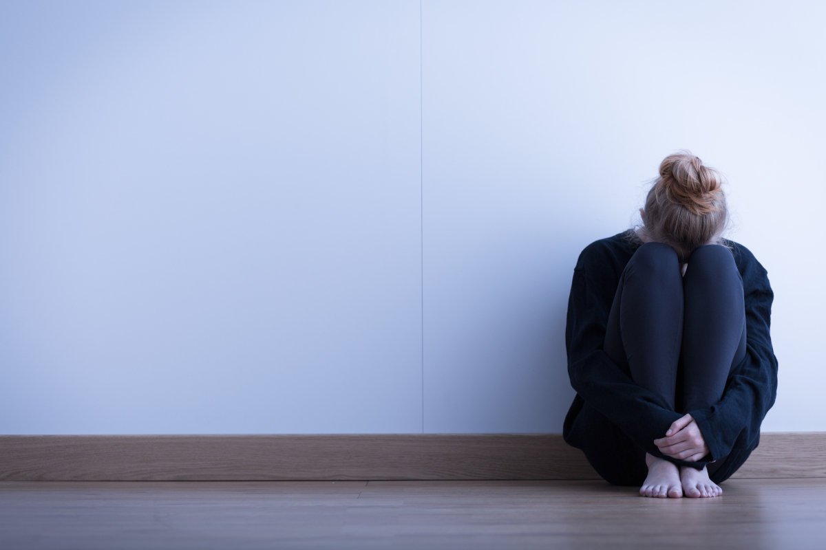 Young woman curled up on a floor