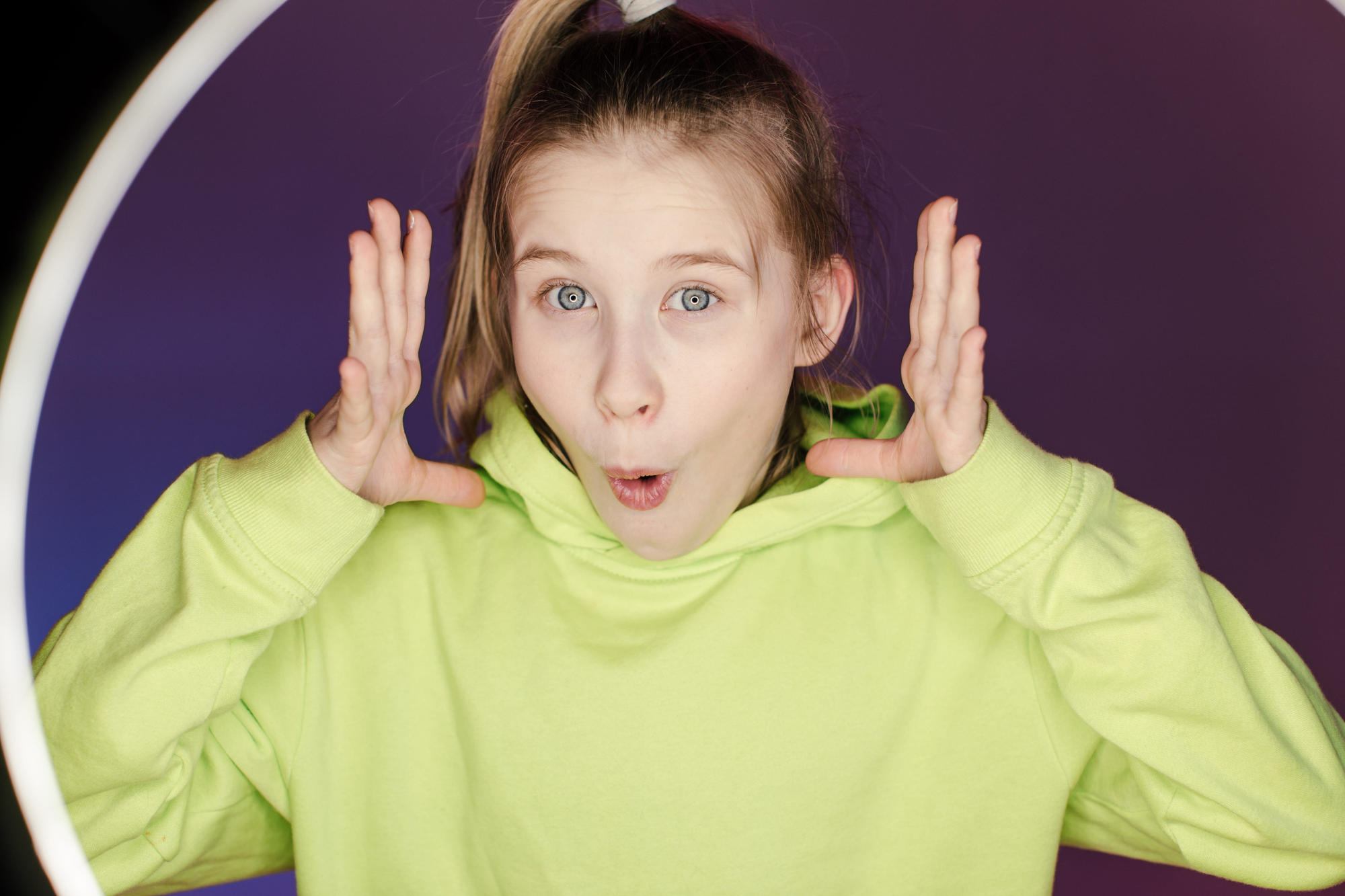 Young stylish girl with colorful neon background