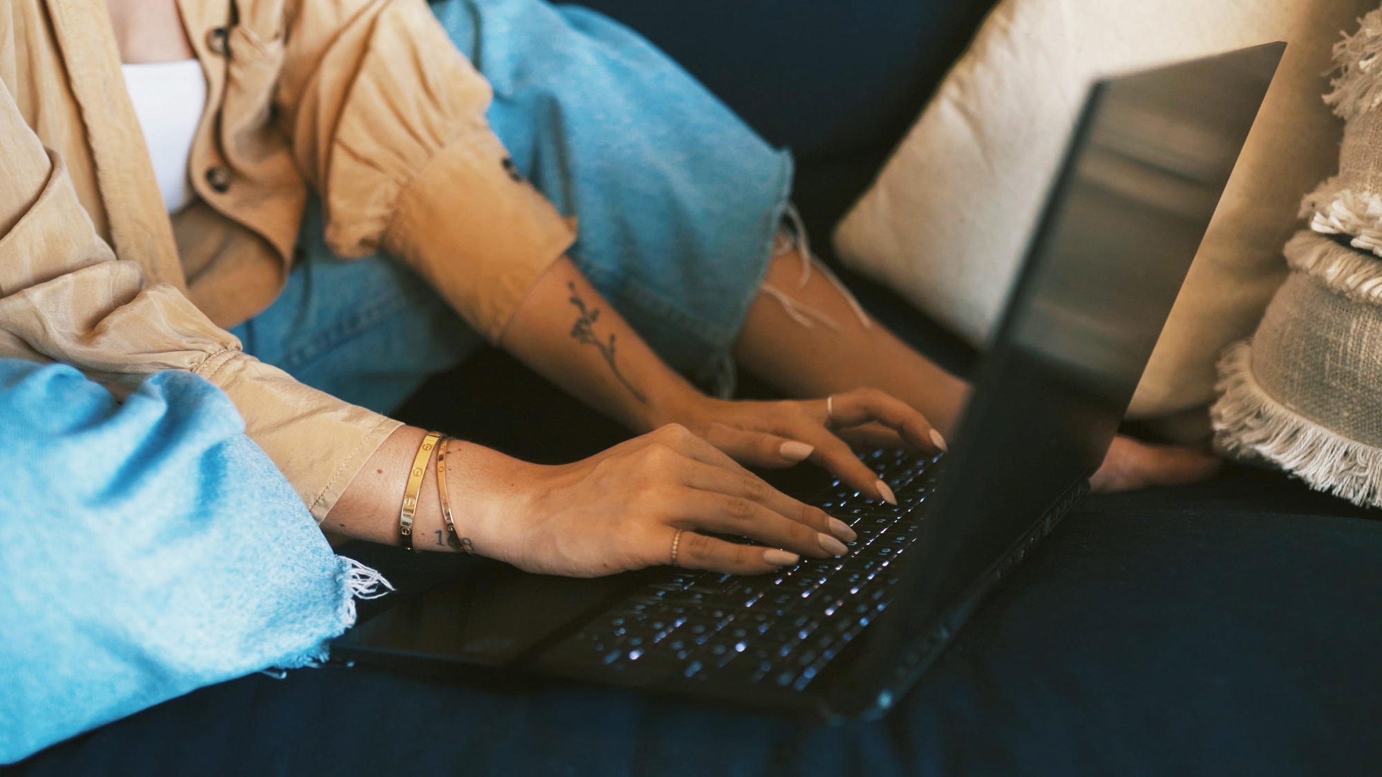Female reading blogs on laptop and having a cup of coffee