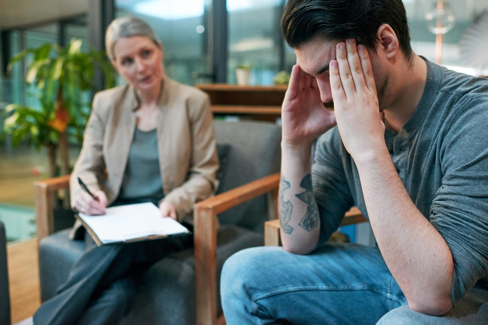 Young man having a therapeutic session with psychologist