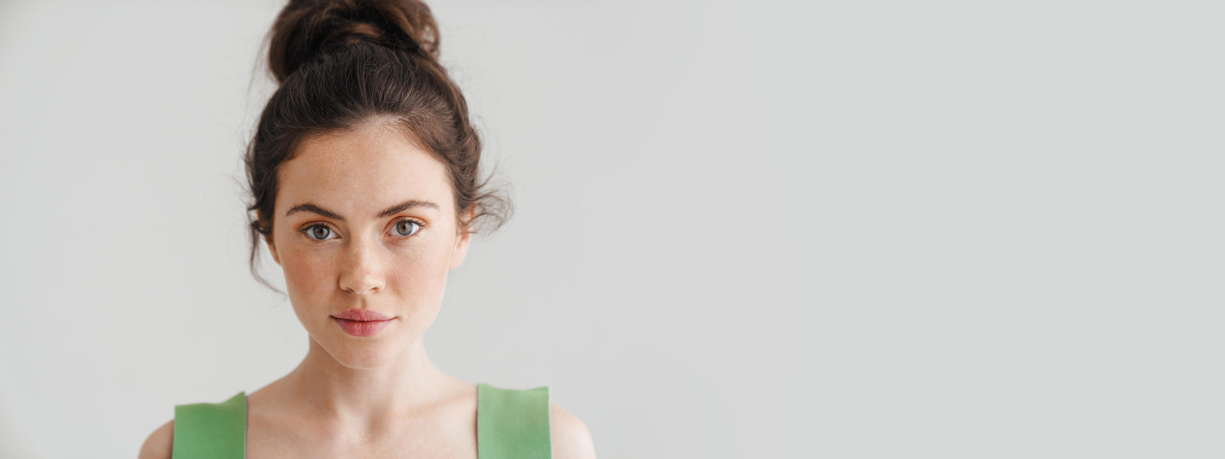 Pretty serious brunette woman posing and looking at camera