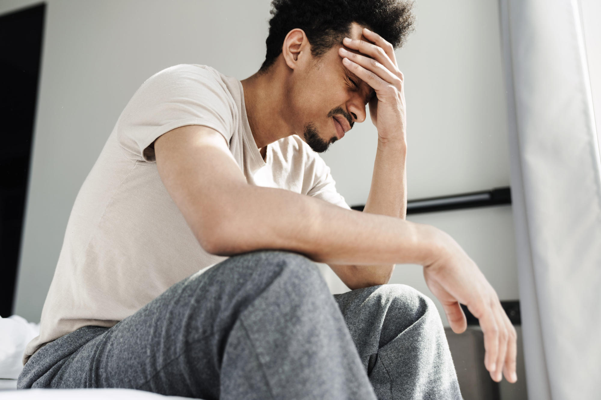 Person unable to sleep sitting on bed