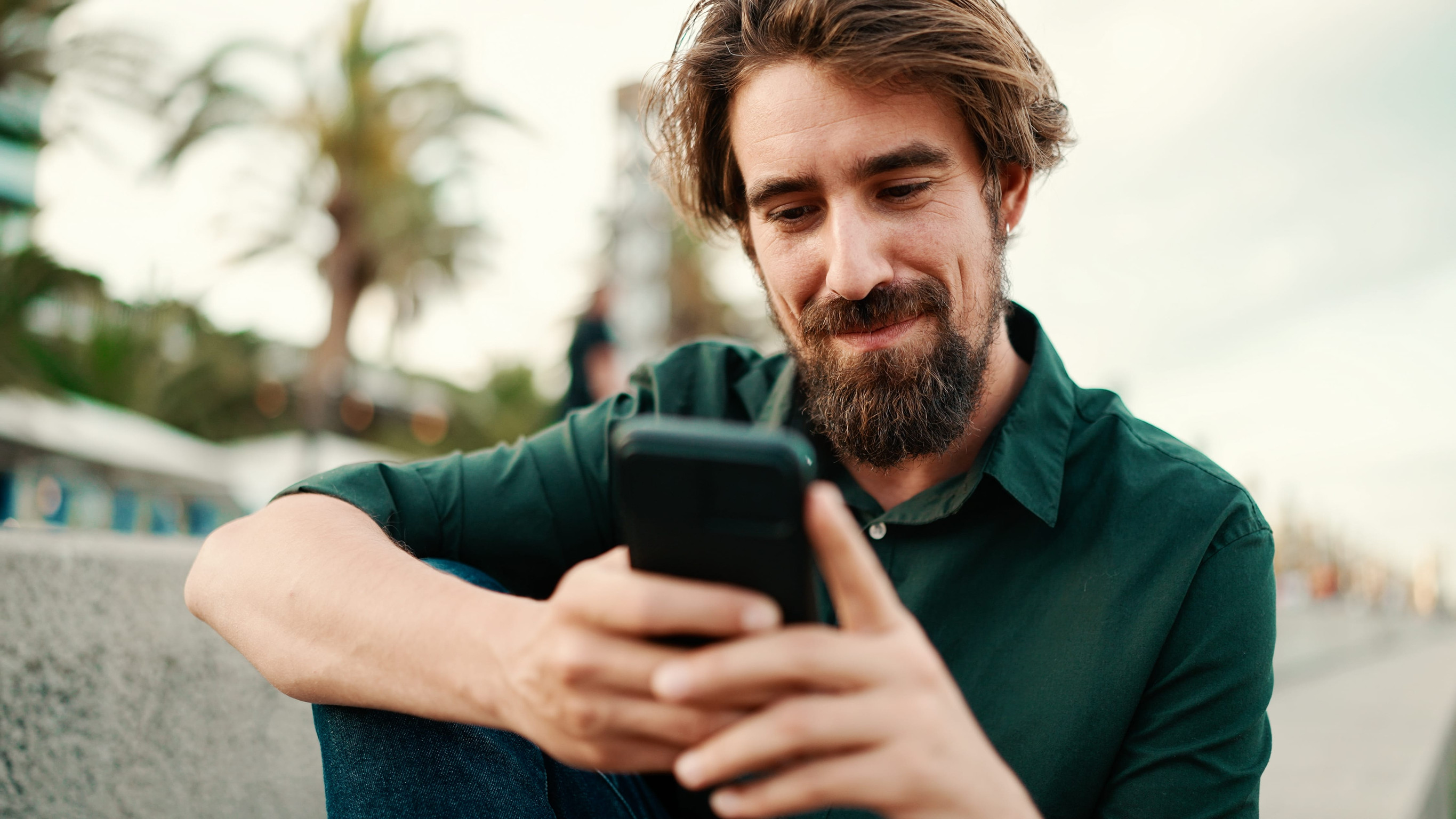Close-up portrait of man with beard recording voice message