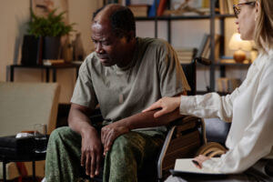 An African American soldier suffering from PTSD during a private therapy session.