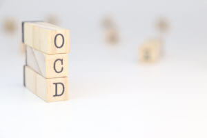 Obsessive-compulsive disorder (OCD) abbreviation on three wooden cubes.