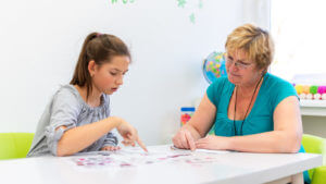 A female ADHD specialist is working with a teenage girl who has Attention-DeficitHyperactivity Disorder (ADHD).