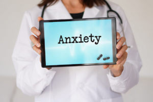 Anxiety concept. words written on a woman doctor's digital tablet